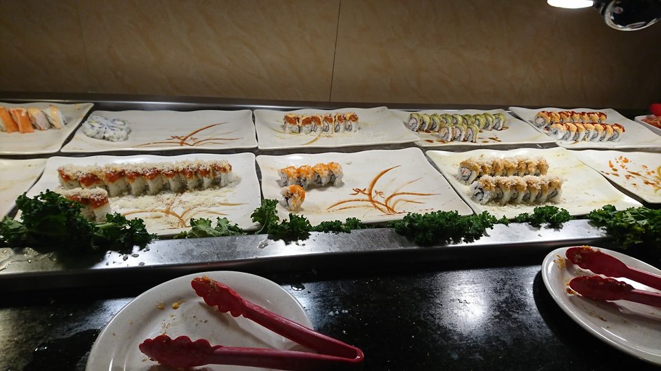 Buffet trays lined with Chinese dishes.